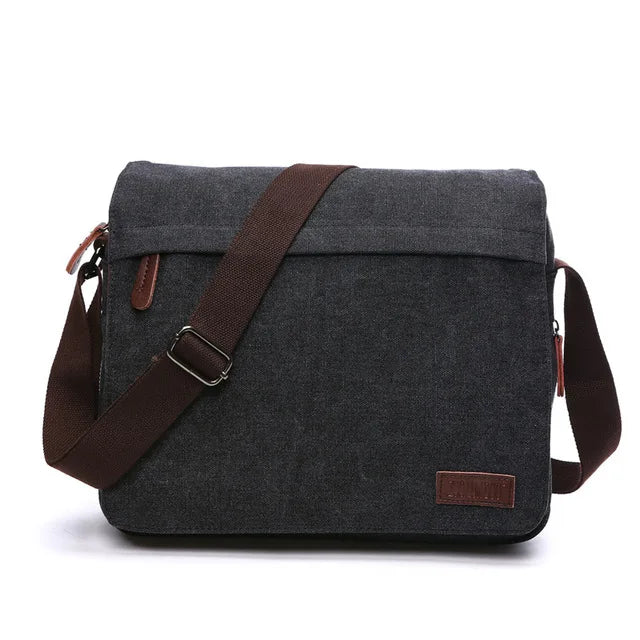 Dark grey canvas messenger bag with brown adjustable strap, Orin & Vale branding