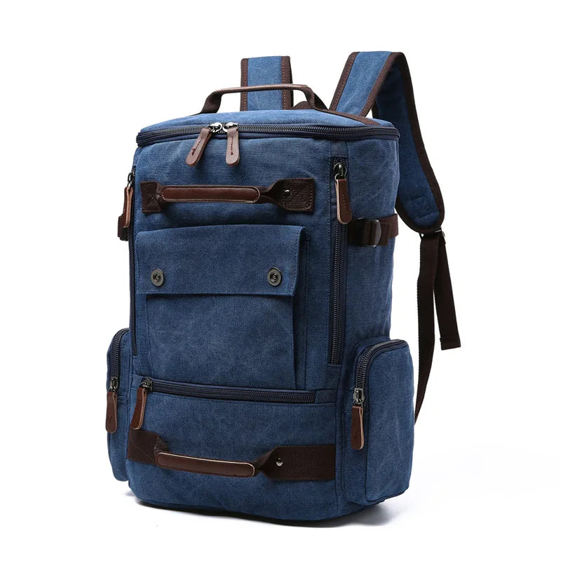 Blue canvas backpack with brown leather accents and multiple zippered pockets, Orin & Vale