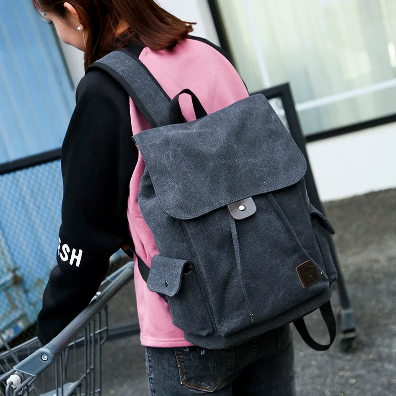 Woman wearing large gray canvas backpack outdoors, Orin & Vale fashion accessory