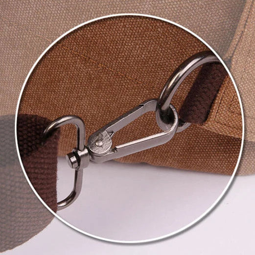 Close-up of metal clasp and brown canvas strap on Orin & Vale bag