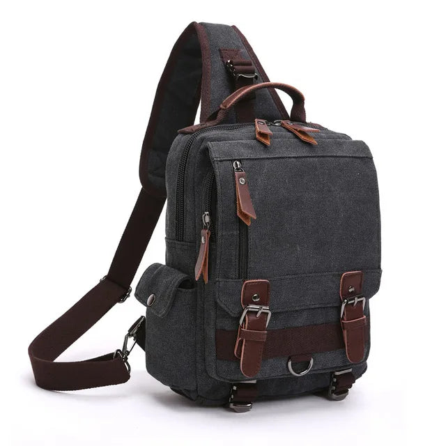 Orin & Vale dark gray canvas sling backpack with brown leather accents and multiple pockets