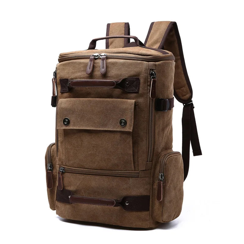 Brown canvas backpack with leather straps and multiple pockets on white background