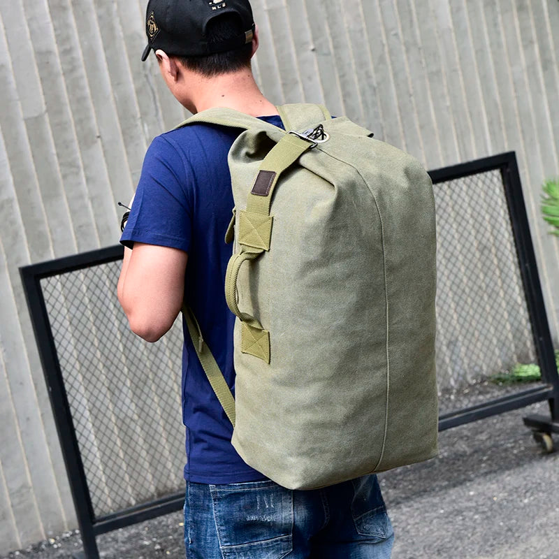 Man wearing large olive green canvas backpack outdoors, Orin & Vale bag