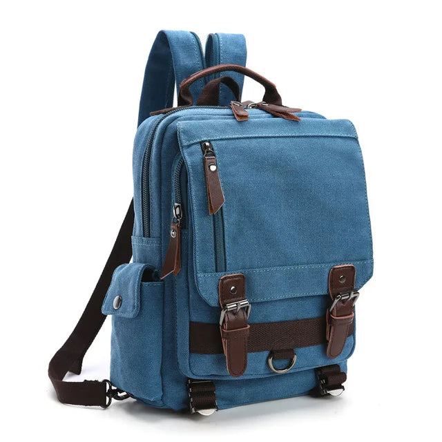 Blue canvas backpack with brown leather straps and multiple pockets from Orin & Vale