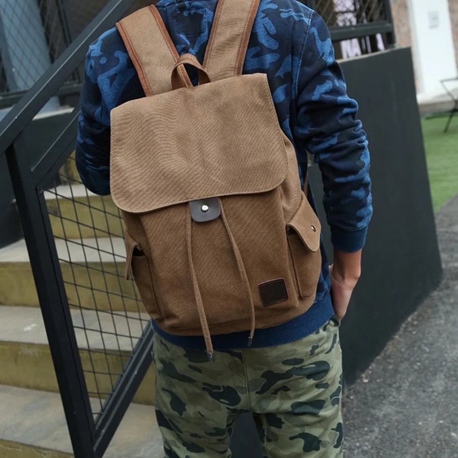 Person wearing a brown canvas backpack outdoors, Orin & Vale casual style