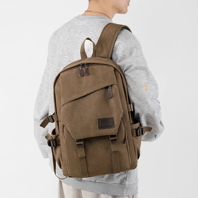 Man wearing a brown canvas backpack, Orin & Vale, casual fashion, side view