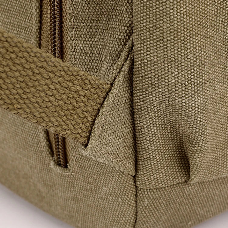Close-up of khaki canvas bag corner with sturdy strap and zipper, Orin & Vale